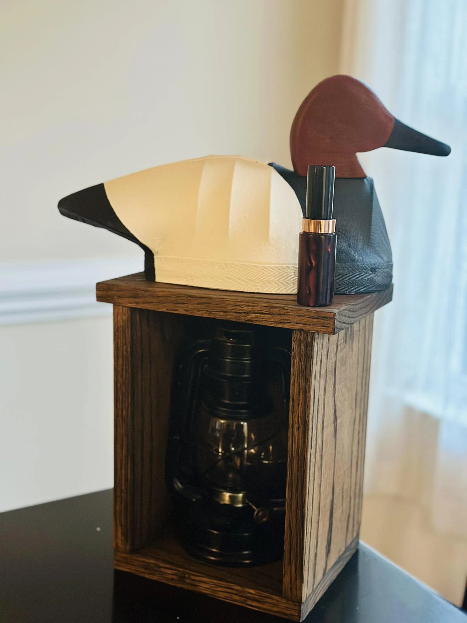 GroundSwat decoy displayed on a wooden crate with a lantern and game call.